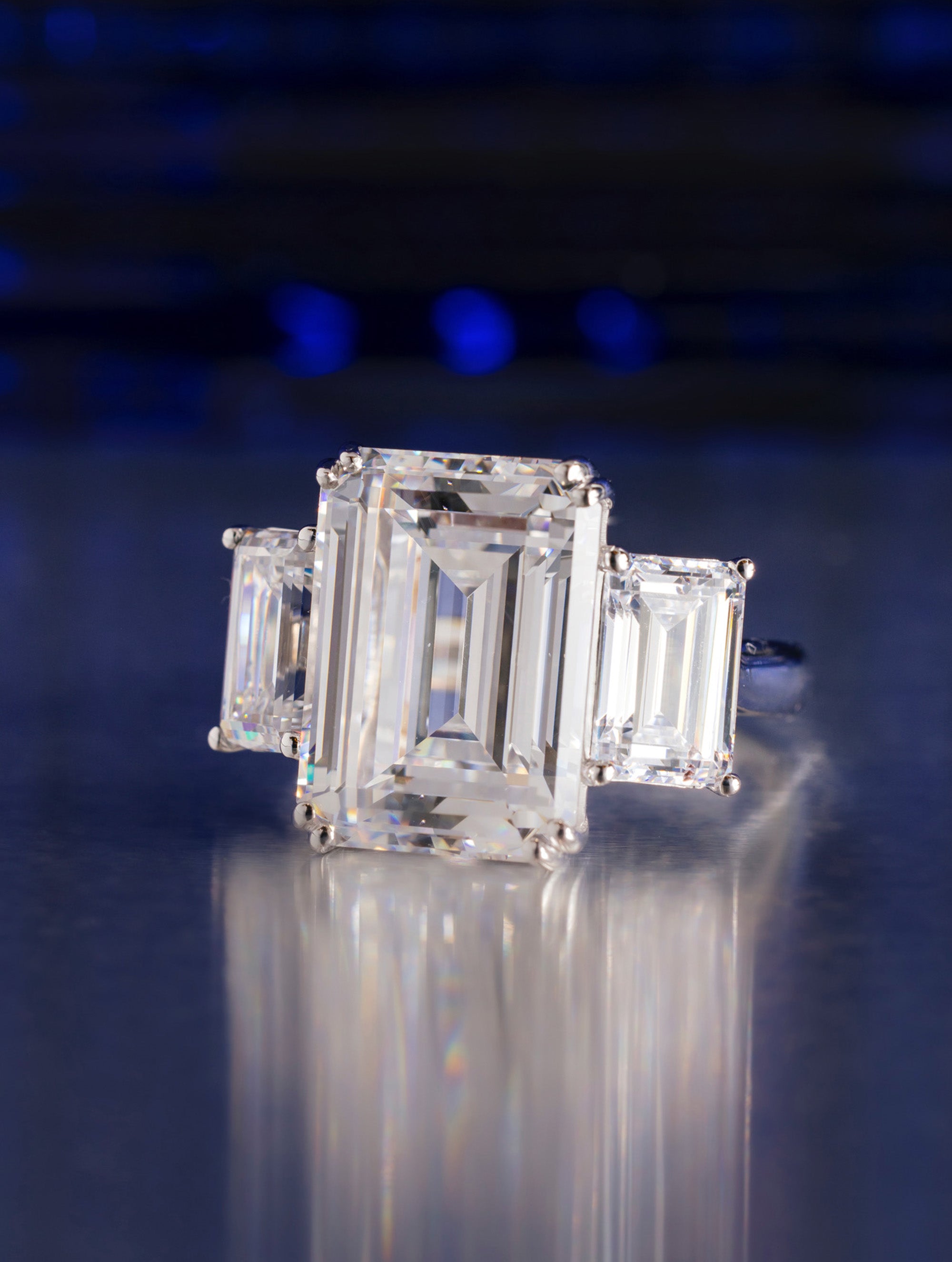 THREE STONE EMERALD CUT DIAMOND RING